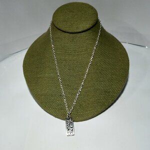 Women`s silver tone filigree bar necklace.